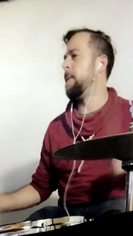 Jared at the drum kit, mid-fill, off-hours studio.